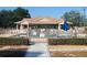 Gated community pool with seating and shade, offering a relaxing amenity at 6239 Sw 98Th Loop, Ocala, FL 34476