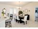Formal dining room featuring elegant furniture, tile floors, and decorative mirror accents at 6239 Sw 98Th Loop, Ocala, FL 34476