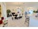 Open-concept dining room featuring tile floors and direct access to the kitchen and the living room at 6239 Sw 98Th Loop, Ocala, FL 34476