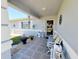 Inviting front porch with decorative seating, welcome decor and tiled flooring at 6239 Sw 98Th Loop, Ocala, FL 34476