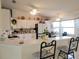 Open-concept kitchen featuring white cabinets, stainless steel appliances and a breakfast bar at 6239 Sw 98Th Loop, Ocala, FL 34476