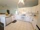 Bright kitchen features white cabinetry, tile backsplash, and modern appliances at 6239 Sw 98Th Loop, Ocala, FL 34476