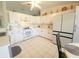 Bright kitchen with white cabinetry, tile floors, and modern appliances offer a clean, contemporary aesthetic at 6239 Sw 98Th Loop, Ocala, FL 34476