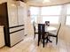 Bright breakfast nook in kitchen features a table, chairs, and large window with natural light at 6239 Sw 98Th Loop, Ocala, FL 34476