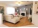 Cozy living room with a white couch, fireplace, and natural light creates an inviting atmosphere at 6239 Sw 98Th Loop, Ocala, FL 34476