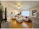 Spacious living room with a white sectional, wood floors, and bright natural light at 6239 Sw 98Th Loop, Ocala, FL 34476