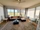 Inviting sunroom with large windows, comfortable seating, and a decorative area rug at 6239 Sw 98Th Loop, Ocala, FL 34476