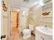Well-lit bathroom with tiled floors, a classic toilet, and a sink vanity with a mirror at 700 Midway Dr # B, Ocala, FL 34472