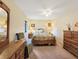 Cozy bedroom featuring soft carpet, ceiling fan, and comfortable furnishings at 700 Midway Dr # B, Ocala, FL 34472