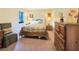 Comfortable bedroom featuring a queen-sized bed and a lovely chair with a decorative pillow at 700 Midway Dr # B, Ocala, FL 34472