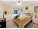 Bright bedroom with a ceiling fan, a white dresser, and a cozy queen bed at 700 Midway Dr # B, Ocala, FL 34472