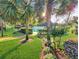 Community pool entrance framed by palm trees and landscaping, showcasing a resort-like atmosphere at 700 Midway Dr # B, Ocala, FL 34472
