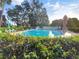 Inviting community pool surrounded by lush greenery and comfortable lounge chairs under a sunny sky at 700 Midway Dr # B, Ocala, FL 34472