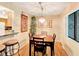 Comfortable dining area with a wooden table, chandelier, and view into kitchen at 700 Midway Dr # B, Ocala, FL 34472
