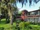Exterior of house with abundance of trees and shrubbery, including screened in porch at 700 Midway Dr # B, Ocala, FL 34472