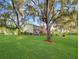 Exterior view of the home, showcasing a spacious lawn and mature trees draped with Spanish moss at 700 Midway Dr # B, Ocala, FL 34472