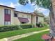 Well-manicured apartment complex exterior with lush green lawn and vibrant shrubbery at 700 Midway Dr # B, Ocala, FL 34472