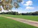 The lush green grass extends out to the lake on this golf course view at 700 Midway Dr # B, Ocala, FL 34472
