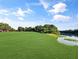 Expansive green space by a tranquil lake, offering a serene and picturesque setting at 700 Midway Dr # B, Ocala, FL 34472