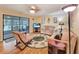 Cozy living room with comfortable seating, ceiling fan, and access to a screened-in porch at 700 Midway Dr # B, Ocala, FL 34472