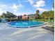 Sparkling community pool surrounded by lush landscaping and comfortable lounge seating at 700 Midway Dr # B, Ocala, FL 34472