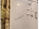 Shower stall equipped with multiple grab bars, a handheld shower head, and built-in shelves at 700 Midway Dr # B, Ocala, FL 34472