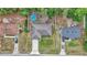Aerial view of a home with a driveaway, backyard, above ground pool, and surrounded by lush trees at 72 Dogwood Loop, Ocala, FL 34472