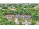 Aerial view of three homes with driveways and fenced in yards surrounded by lush green trees and neighborhood at 72 Dogwood Loop, Ocala, FL 34472