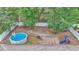 Aerial view of backyard with above-ground pool, playset and pergola at 72 Dogwood Loop, Ocala, FL 34472