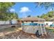 Backyard area featuring a pool, play set and pergola at 72 Dogwood Loop, Ocala, FL 34472