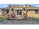 Exterior view of backyard deck with pergola and direct access to the home's interior at 72 Dogwood Loop, Ocala, FL 34472