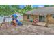 Backyard with wooden deck, play set, pool and white fencing at 72 Dogwood Loop, Ocala, FL 34472