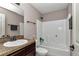 Full bathroom with a shower and tub combination, vanity with dark cabinets, and ample lighting at 72 Dogwood Loop, Ocala, FL 34472