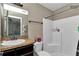 Bathroom featuring a shower and tub combination, vanity with dark cabinets, and ample lighting at 72 Dogwood Loop, Ocala, FL 34472