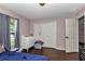 Bedroom featuring laminate wood flooring, light pink walls, window and closet at 72 Dogwood Loop, Ocala, FL 34472