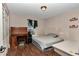 Small bedroom featuring laminate floors, a window, a desk and a full sized bed at 72 Dogwood Loop, Ocala, FL 34472