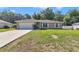 Charming single-story home with a well-manicured lawn, a two-car garage, and mature landscaping at 72 Dogwood Loop, Ocala, FL 34472