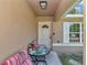 Cozy front porch featuring a seating area, perfect for relaxing and enjoying the outdoors at 72 Dogwood Loop, Ocala, FL 34472