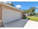 A close-up of a two-car garage with a white door, showcasing the home's exterior at 72 Dogwood Loop, Ocala, FL 34472