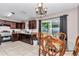 Inviting eat-in kitchen area with wooden cabinets, stainless steel appliances, and sliding glass door to the patio at 72 Dogwood Loop, Ocala, FL 34472