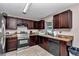 A functional kitchen featuring stainless steel appliances, tiled floors, and wooden cabinetry at 72 Dogwood Loop, Ocala, FL 34472