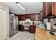 Functional kitchen features stainless steel appliances, dark cabinetry, and durable countertops, perfect for cooking at 72 Dogwood Loop, Ocala, FL 34472