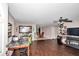 Expansive living area with rich wood flooring, ceiling fan, desk space and entertainment center at 72 Dogwood Loop, Ocala, FL 34472