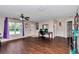 Bright living room showcasing wood floors, ceiling fan, desk space, and a welcoming entrance at 72 Dogwood Loop, Ocala, FL 34472