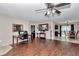 Open concept living room with wood floors, connecting seamlessly to dining and kitchen at 72 Dogwood Loop, Ocala, FL 34472
