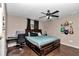 Spacious bedroom featuring a ceiling fan, desk, wood flooring, and ample natural light at 72 Dogwood Loop, Ocala, FL 34472