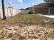 Fenced backyard, utility connections, and a neutral-toned garage blending functionality with an understated aesthetic appeal at 77 Dogwood Drive Pass, Ocala, FL 34472