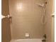 Bathroom shower and tub area with beige tile and shower head at 77 Dogwood Drive Pass, Ocala, FL 34472