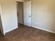 Empty bedroom featuring tile floors, neutral walls, and a double door at 77 Dogwood Drive Pass, Ocala, FL 34472