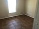A bright bedroom featuring tiled flooring and a window providing natural light at 77 Dogwood Drive Pass, Ocala, FL 34472
